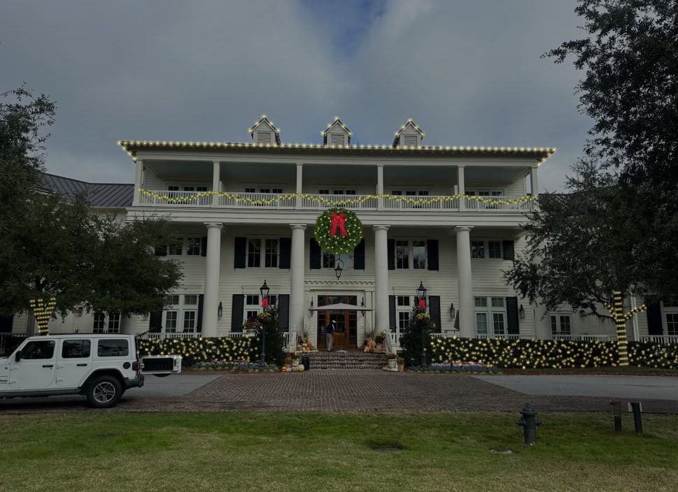 White colonial mansion holiday lighting